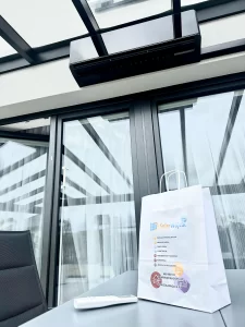 Czarny klimatyzator Rotenso Teta Mirror zamontowany w przeszklonym ogrodzie zimowym